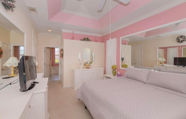 bedroom featuring visible vents, a raised ceiling, crown molding, and light colored carpet