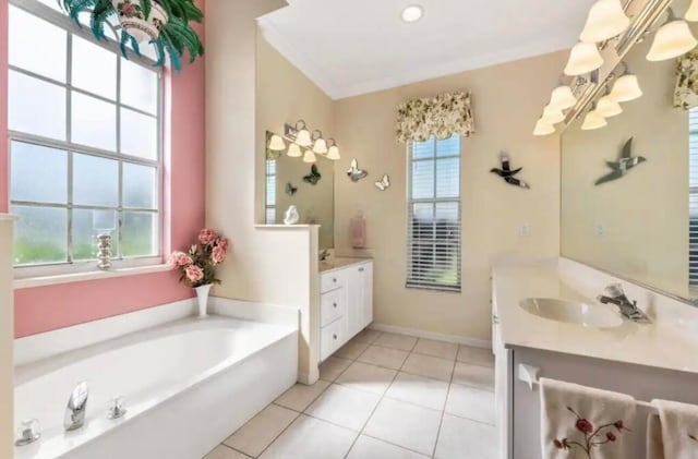 bathroom with a garden tub, two vanities, a sink, baseboards, and tile patterned floors