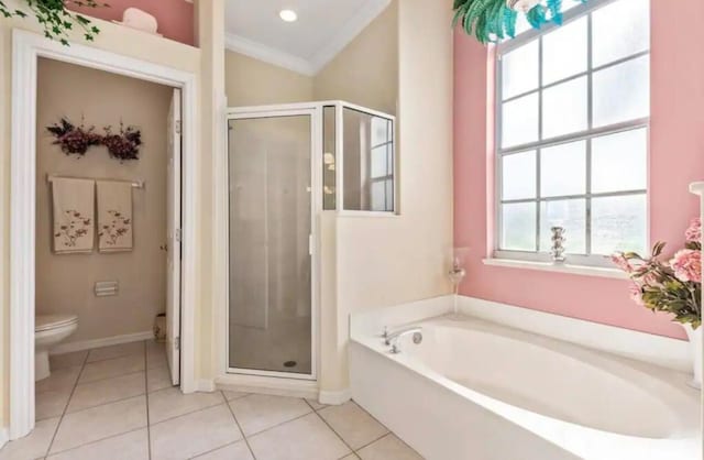 bathroom with a garden tub, a stall shower, tile patterned flooring, and toilet