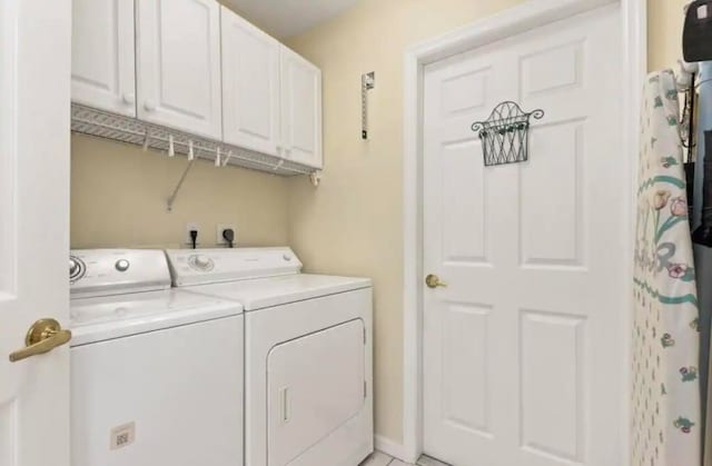 clothes washing area with cabinet space and separate washer and dryer