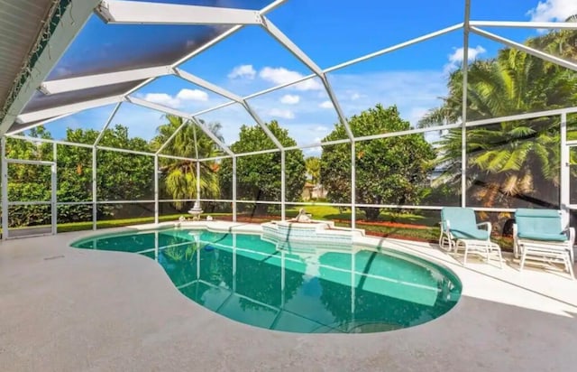 outdoor pool with a patio and a lanai