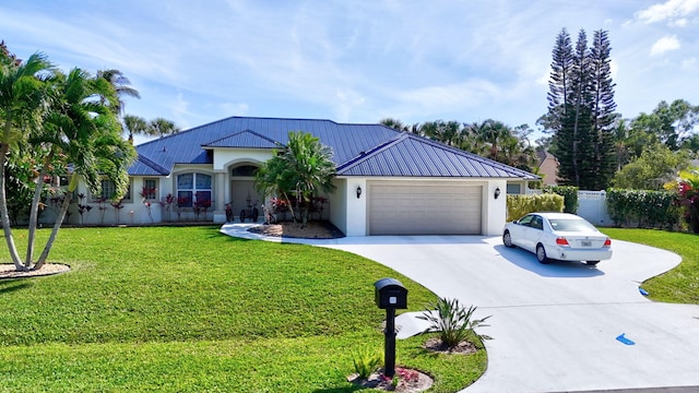 ranch-style house featuring a garage, concrete driveway, metal roof, a front yard, and stucco siding