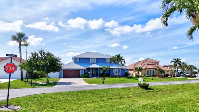 view of front of property with a front yard, driveway, and an attached garage