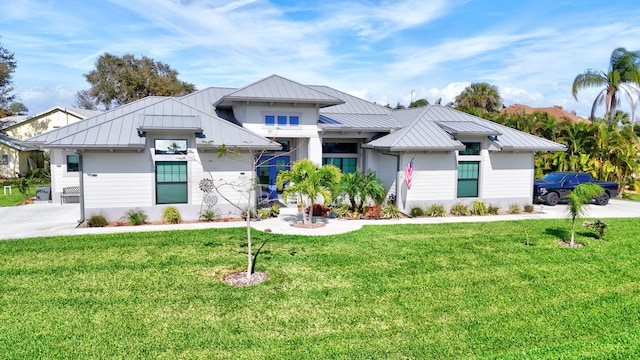 view of front of home with metal roof, a front lawn, and a standing seam roof