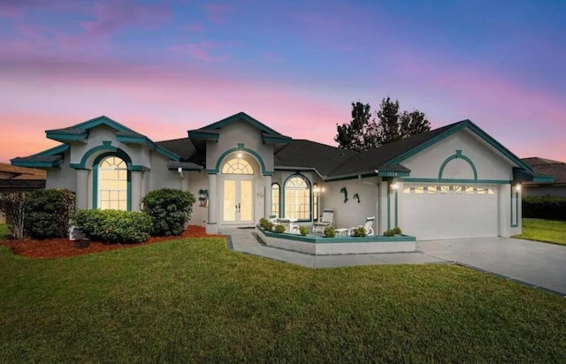 ranch-style home featuring a yard and stucco siding