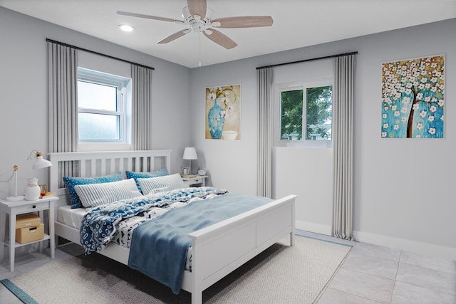 tiled bedroom with multiple windows and ceiling fan