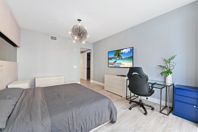 bedroom with light wood-type flooring, floor to ceiling windows, and a notable chandelier