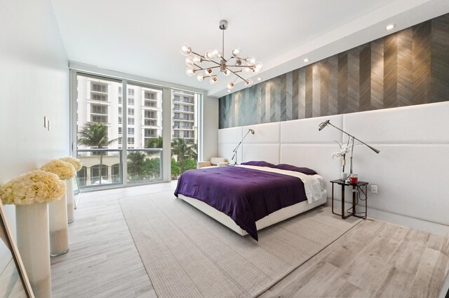 bathroom with floor to ceiling windows, wood-type flooring, and an enclosed shower