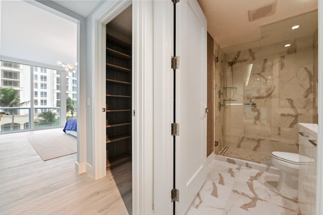 bathroom with vanity, toilet, hardwood / wood-style floors, and an enclosed shower