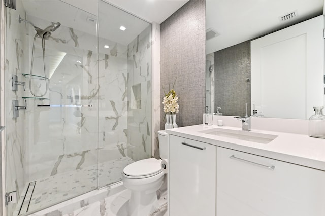 bathroom featuring vanity, toilet, and an enclosed shower