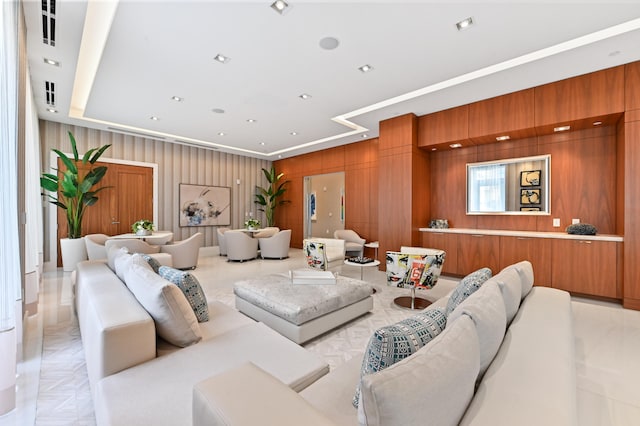 living room with wood walls and light parquet flooring