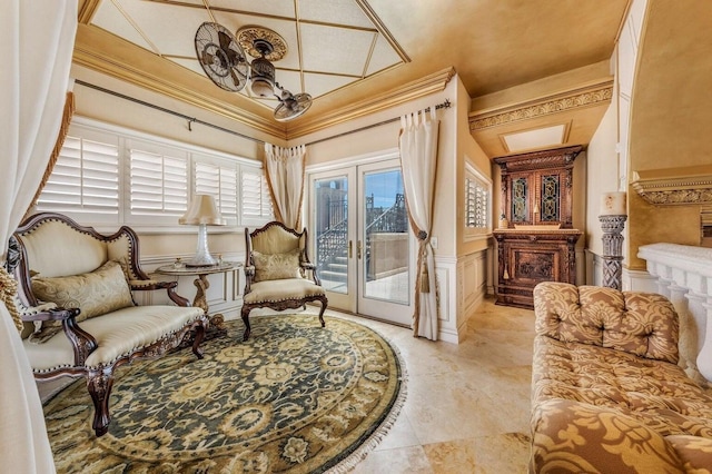 sitting room featuring french doors, a fireplace, and ornamental molding