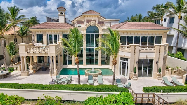 back of house with a balcony and a patio area