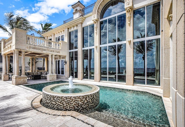 view of pool with an outdoor living space and a patio area