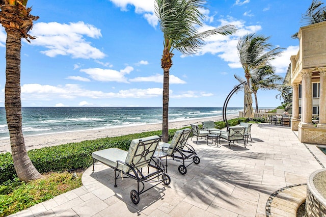 view of patio / terrace featuring a view of the beach and a water view