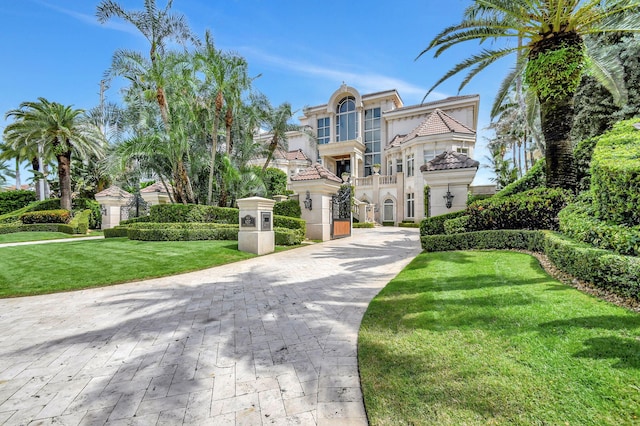 view of front of property with a front yard and a balcony