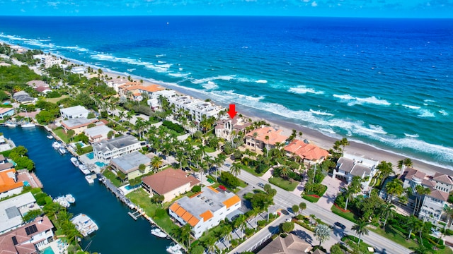 bird's eye view featuring a water view and a beach view