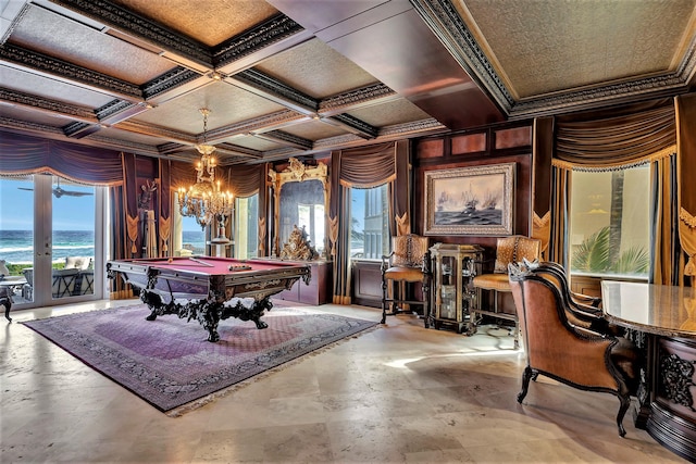 playroom featuring french doors, coffered ceiling, an inviting chandelier, billiards, and a water view