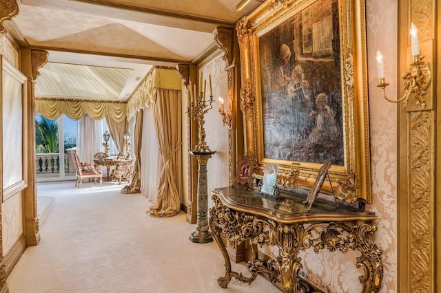 hall with ornamental molding and carpet flooring