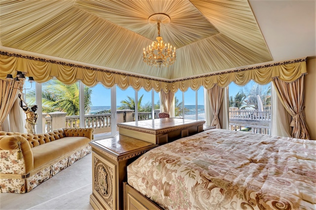 carpeted bedroom featuring multiple windows, access to outside, a water view, and a notable chandelier