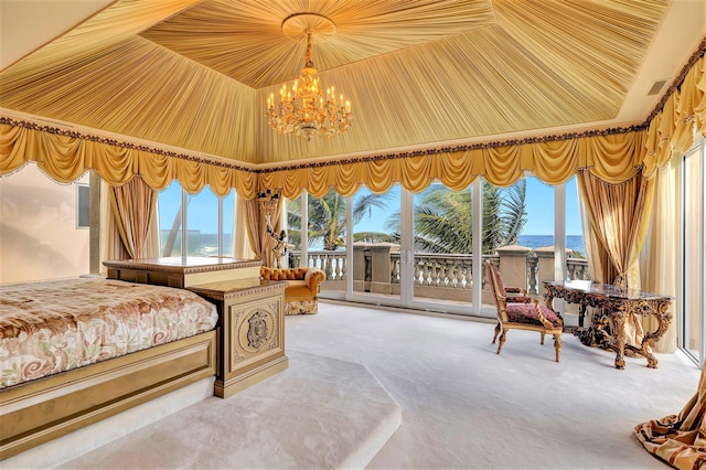 carpeted bedroom with access to outside, a notable chandelier, and a water view