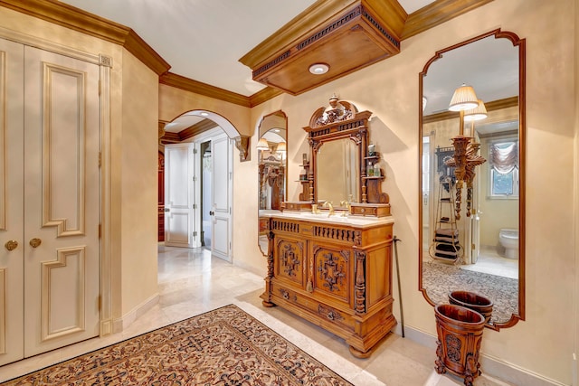 hall featuring sink and ornamental molding