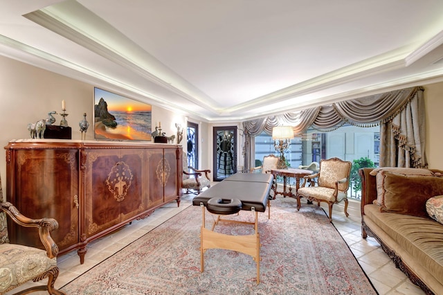 sitting room featuring ornamental molding, a tray ceiling, and light tile patterned floors