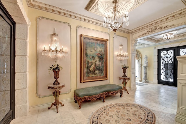 foyer with an inviting chandelier and crown molding