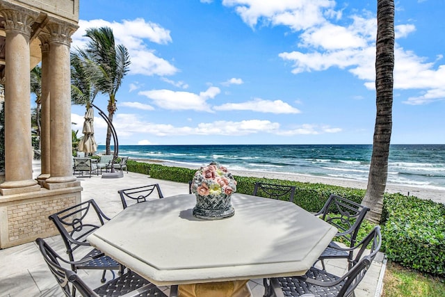 view of patio / terrace featuring a water view and a view of the beach