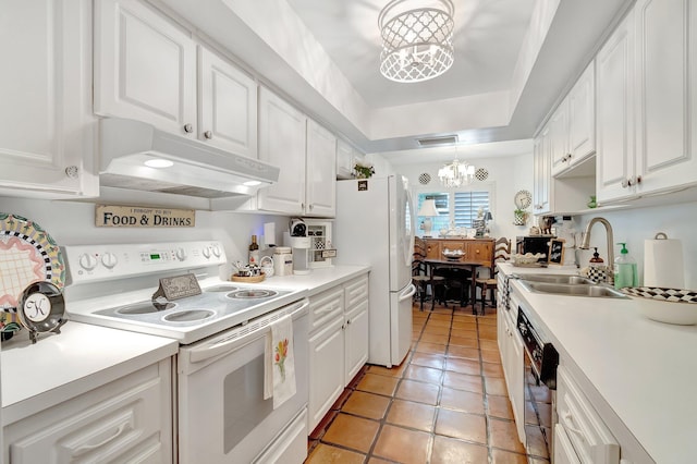 kitchen featuring white appliances, hanging light fixtures, sink, white cabinetry, and an inviting chandelier