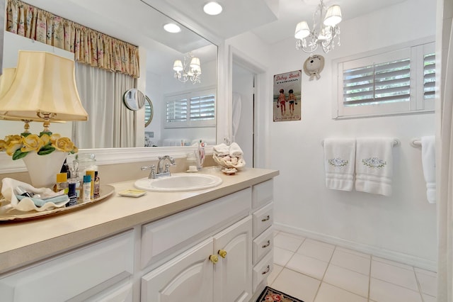 bathroom featuring vanity, tile patterned floors, and a chandelier