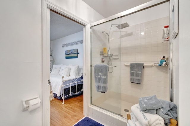 bathroom featuring an enclosed shower and hardwood / wood-style flooring