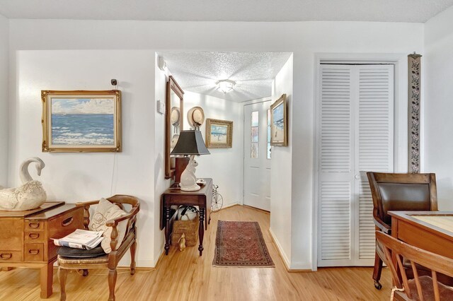 interior space featuring a textured ceiling and light hardwood / wood-style flooring