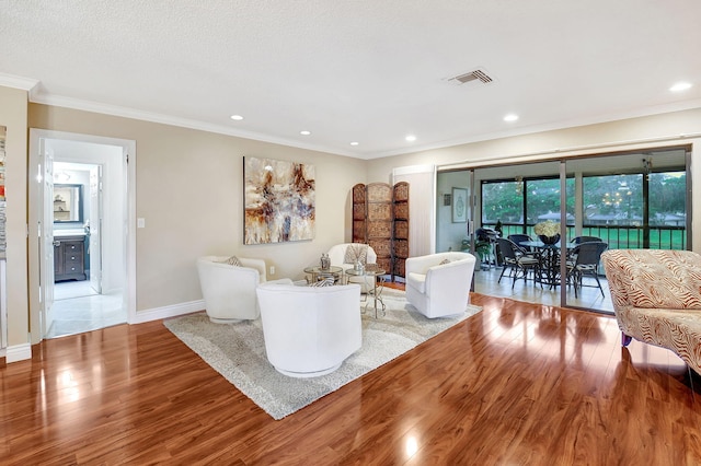 living room with ornamental molding and light wood-type flooring