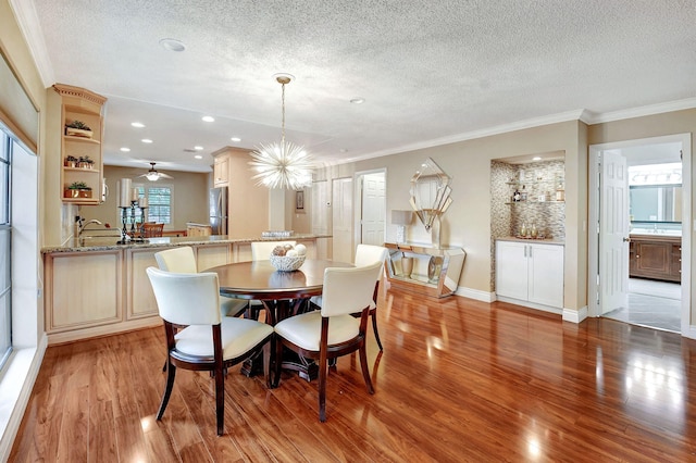 dining area featuring a textured ceiling and light hardwood / wood-style floors