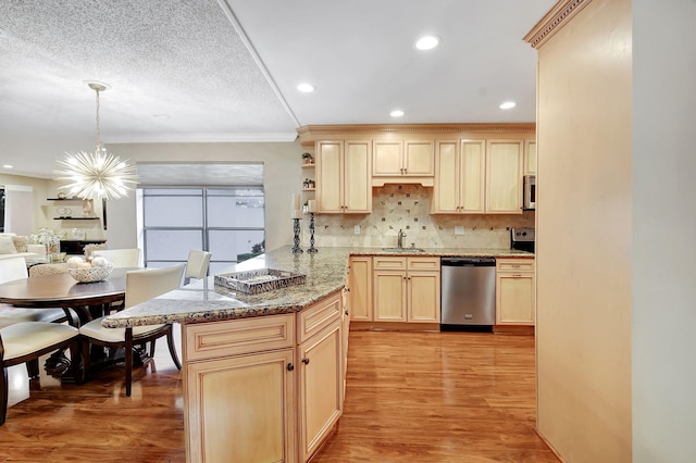 kitchen featuring appliances with stainless steel finishes, decorative backsplash, light hardwood / wood-style floors, and kitchen peninsula