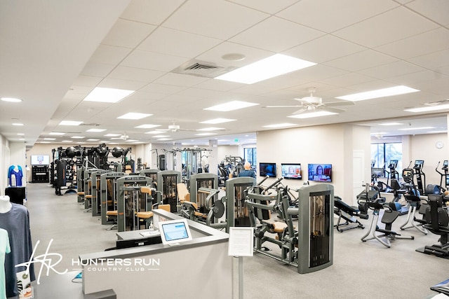 gym featuring a paneled ceiling and ceiling fan