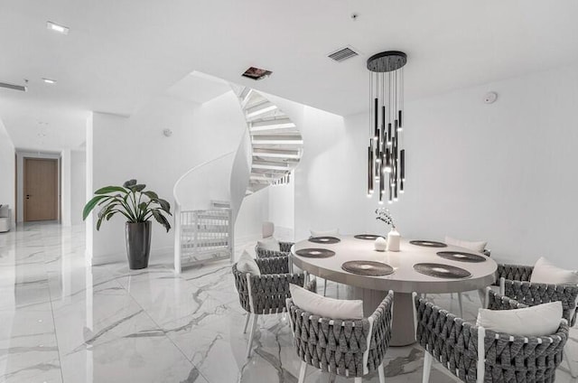 dining space featuring visible vents and marble finish floor