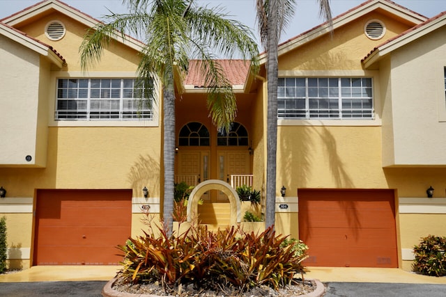 view of front of home featuring stucco siding and a garage