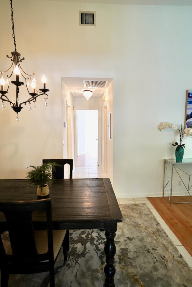 dining area with a notable chandelier and hardwood / wood-style flooring