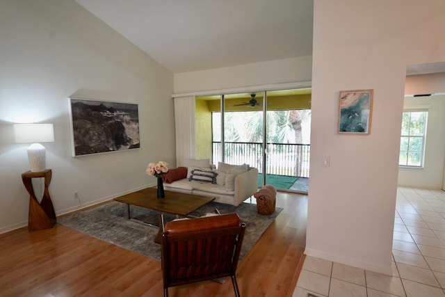 living room featuring ceiling fan, lofted ceiling, and light hardwood / wood-style floors