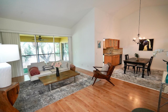 2121 S Ocean Blvd Unit 804, Lauderdale By The Sea, FL 33062 - living area featuring a chandelier, light wood-type flooring, ceiling fan, and high vaulted ceiling