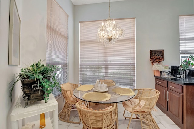 dining area featuring light tile patterned flooring and a notable chandelier