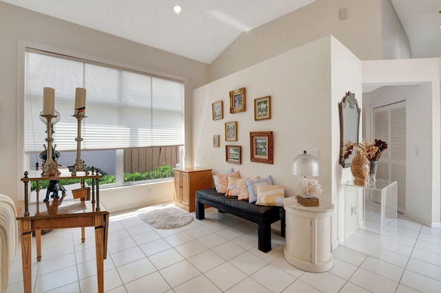 living room with lofted ceiling and light tile patterned floors