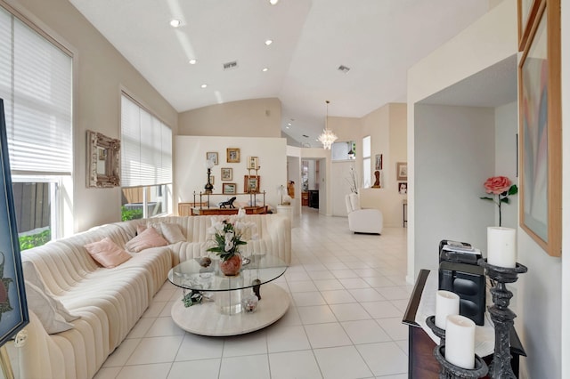 living room with an inviting chandelier, light tile patterned flooring, and vaulted ceiling