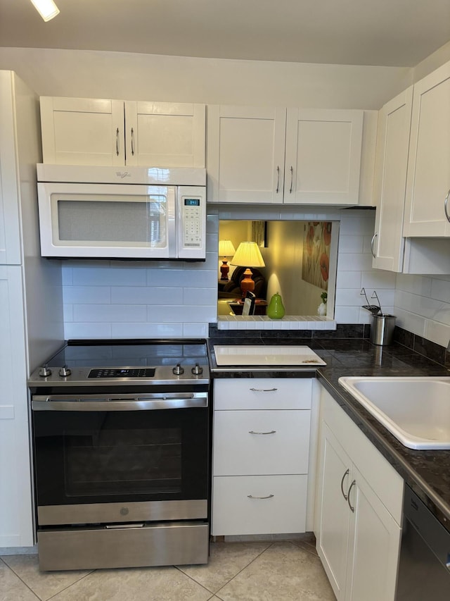 kitchen with sink, stainless steel electric range, dishwasher, backsplash, and white cabinets