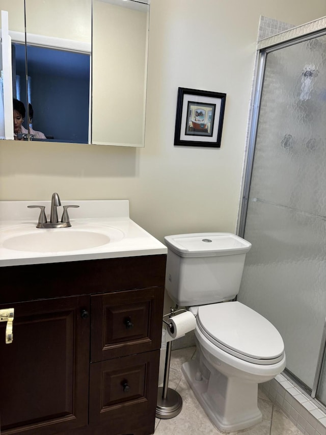 bathroom with vanity, an enclosed shower, tile patterned flooring, and toilet