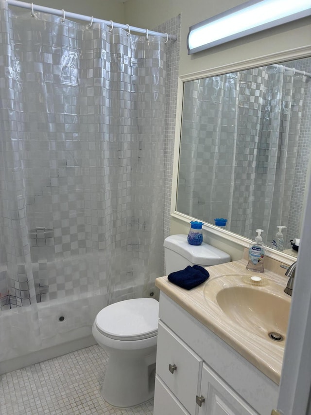 full bathroom with tile patterned floors, toilet, shower / bath combo with shower curtain, and vanity