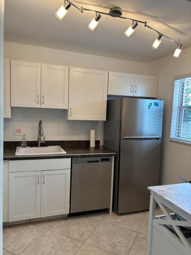 kitchen featuring white cabinets, stainless steel appliances, and sink