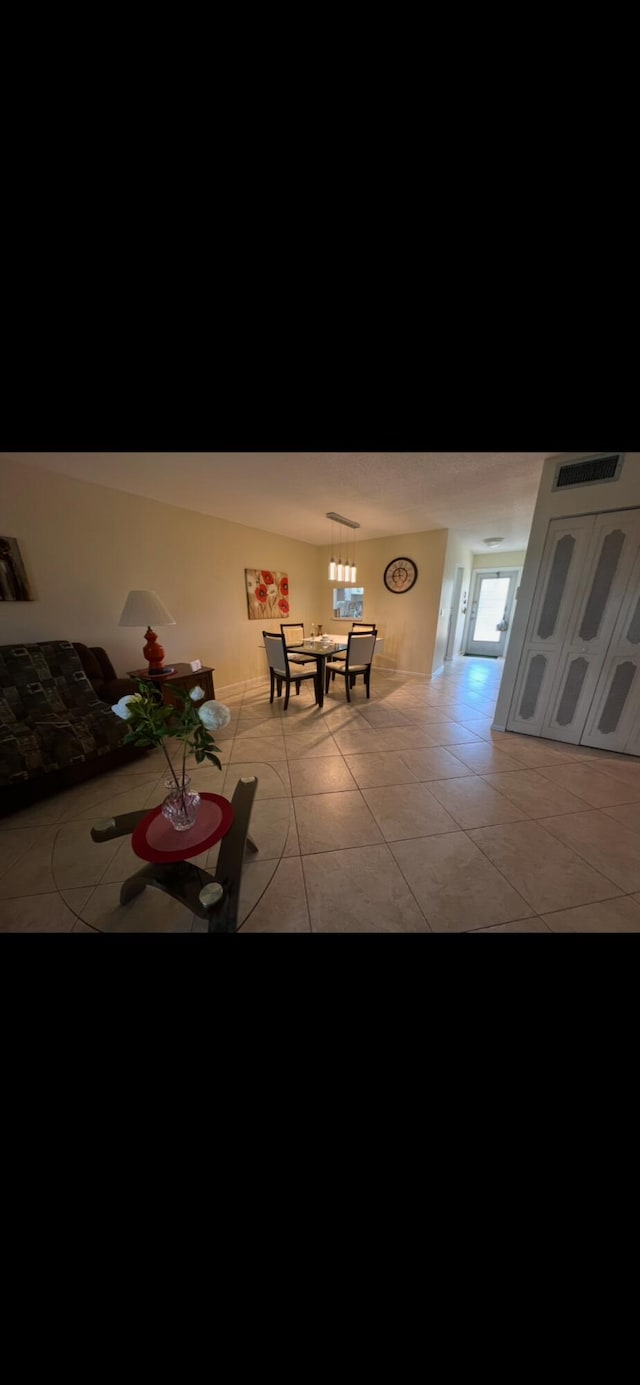 dining area featuring light tile patterned floors